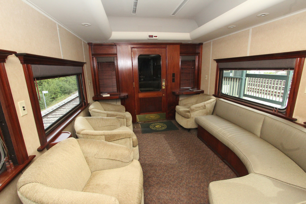 Chairs and sofas inside railroad car.
