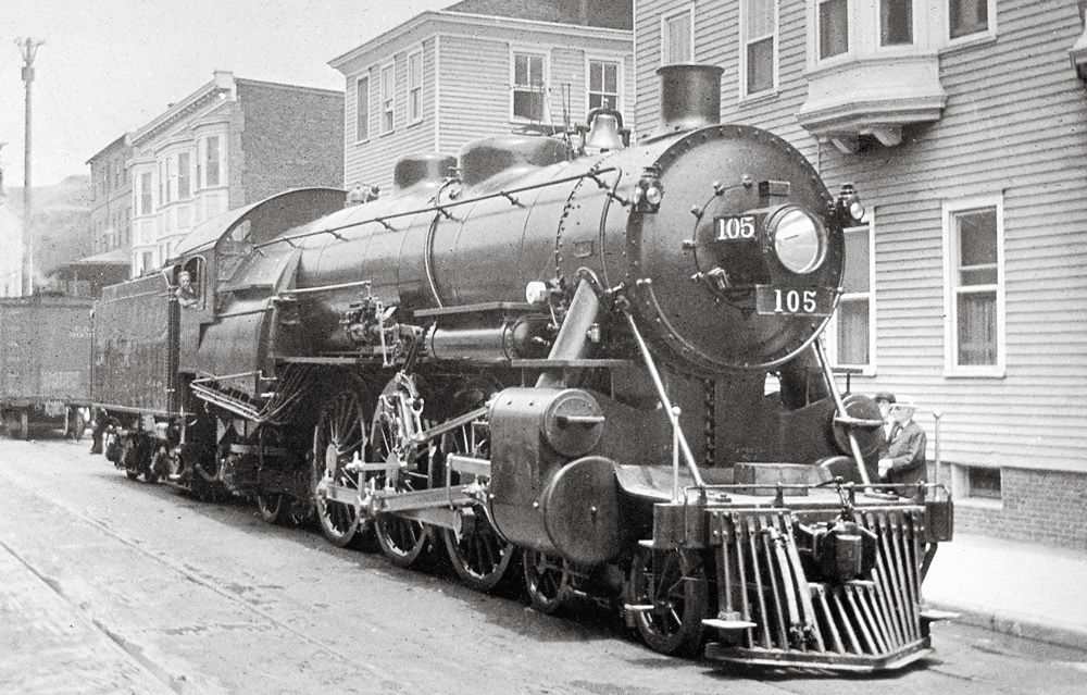 Black-and-white three-quarter right-side photo of 4-6-2 steam locomotive at rest