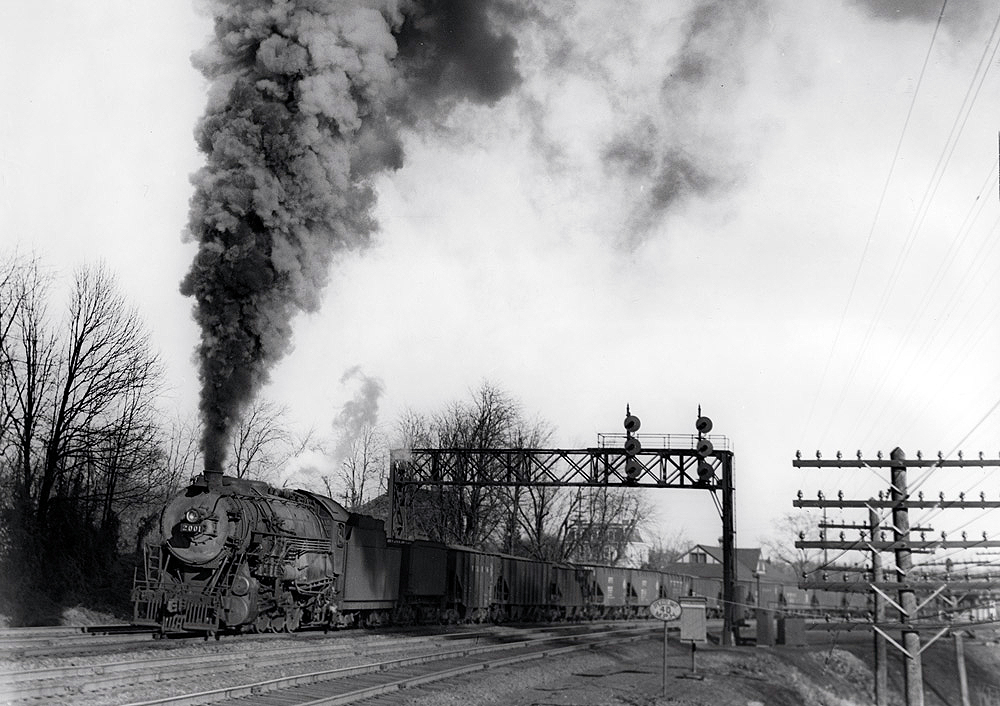 Black-and-white photo of steam locomotive with Reading Company freight train