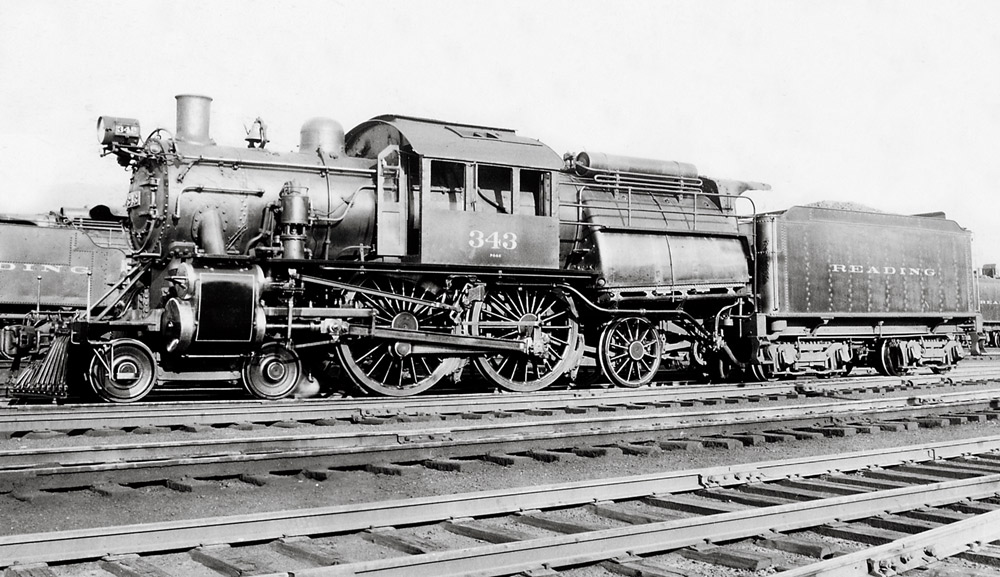 Black-and-white left-side photo of Camelback 4-4-2 steam locomotive at rest