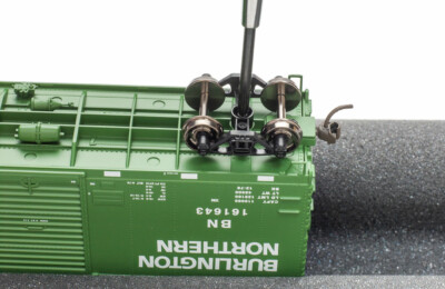 Leave trucks loose on model railroad freight cars