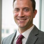 Smiling man in coat and tie