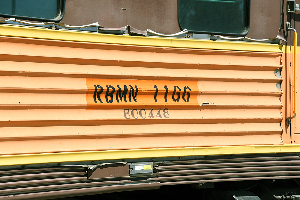Close up of reporting marks for the Reading, Blue Mountain & Northern Railroad newly stenciled on the side of a faded car.