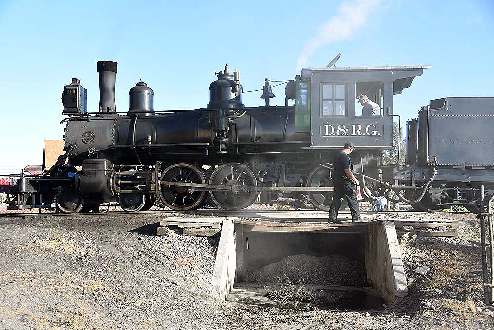 A 4-6-0 steam locomotive poses over a pit.