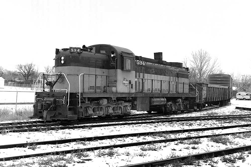 Diesel hood locomotive with freight cars on curve