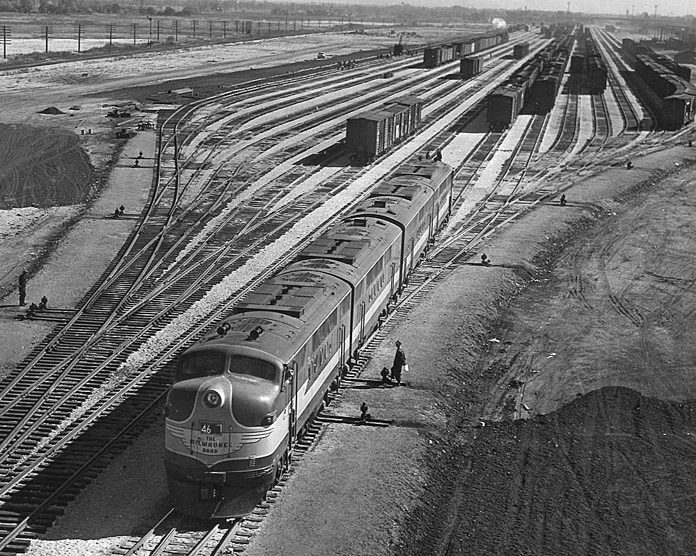 Streamlined diesel locomotives with freight cars in new rail yard