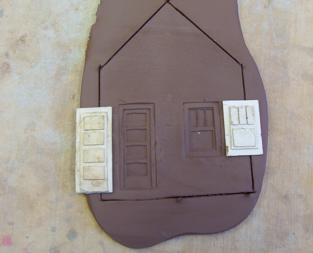 Window and doors embossed into a clay building side