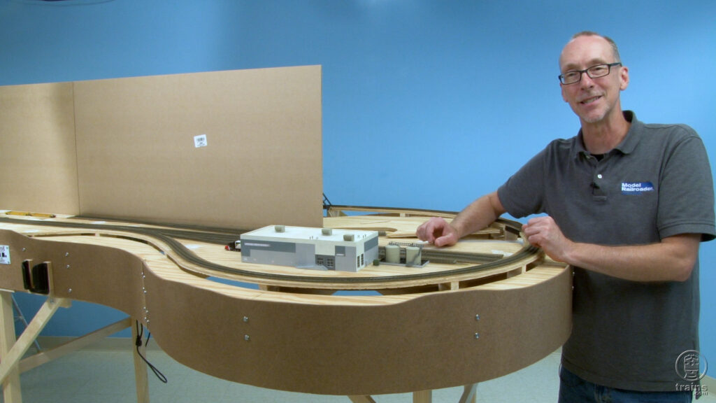 David Popp standing next to a structure placed on the N scale State Line Route layout
