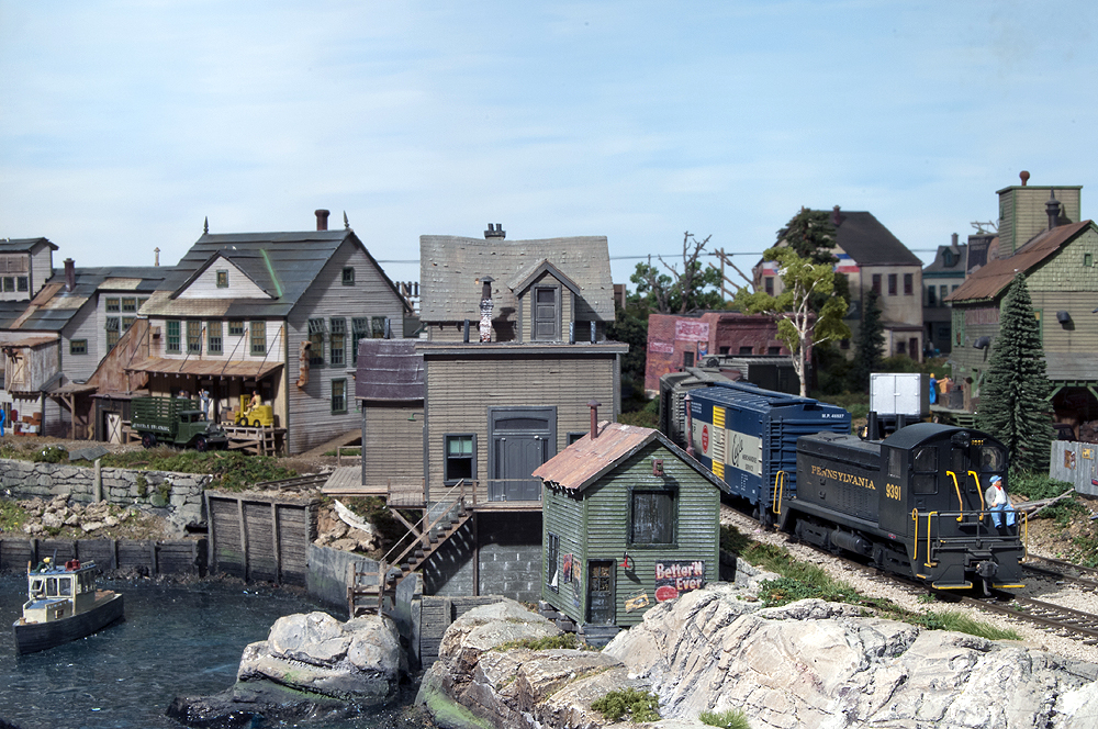 A train traveling alongside a waterfront town
