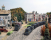 A train passes through a downtown scene
