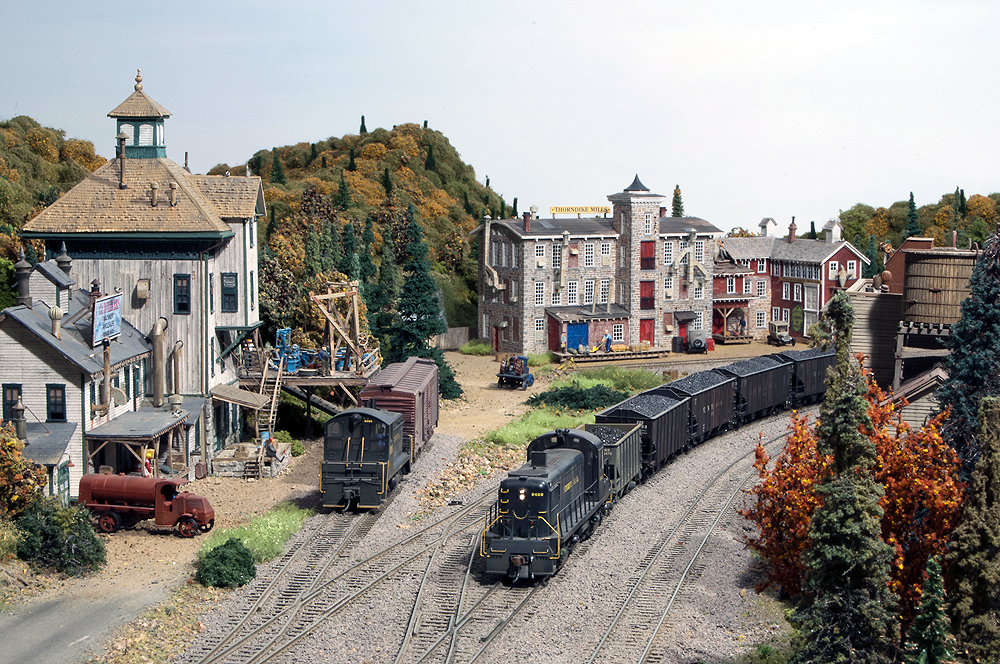 A train passes through a downtown scene