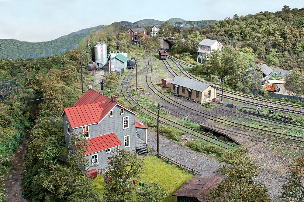 A small yard surrounded by hillsides covered in dense foliage