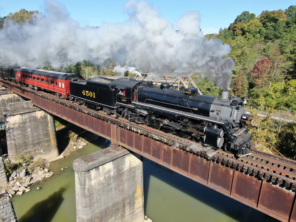 Steam locomotive with passenger train on bridge