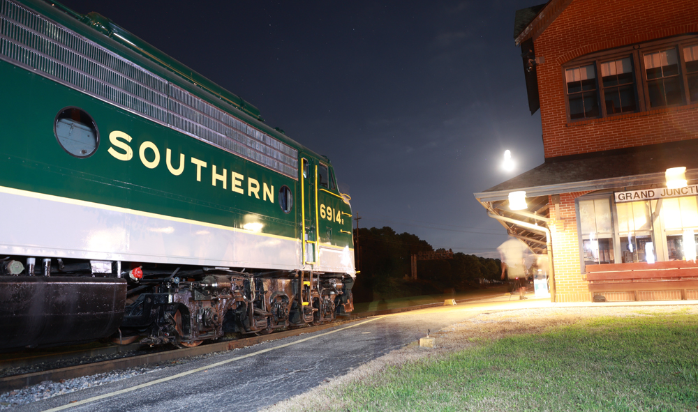 Streamlined passenger diesel at railway depot at night