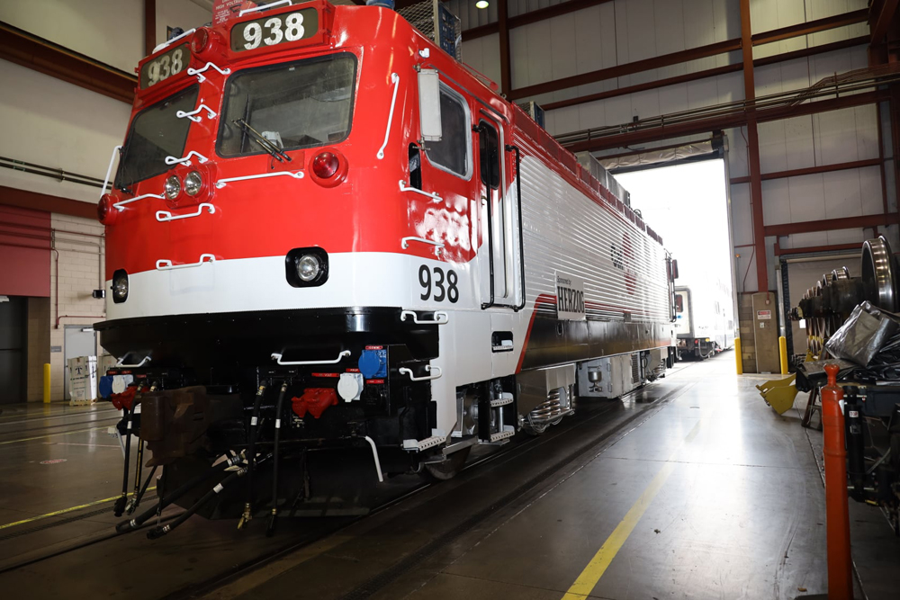 Three-quarters view of red, black, and white electric locomotive