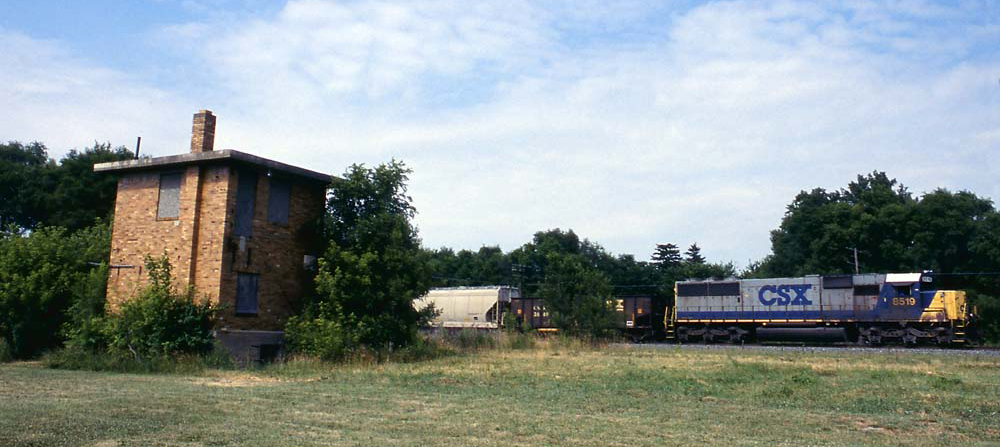 Train passing closed brick tower