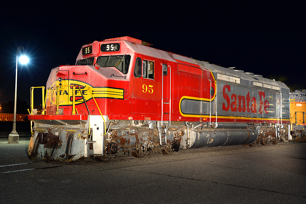 Red and silver locomotive at nighttime.
