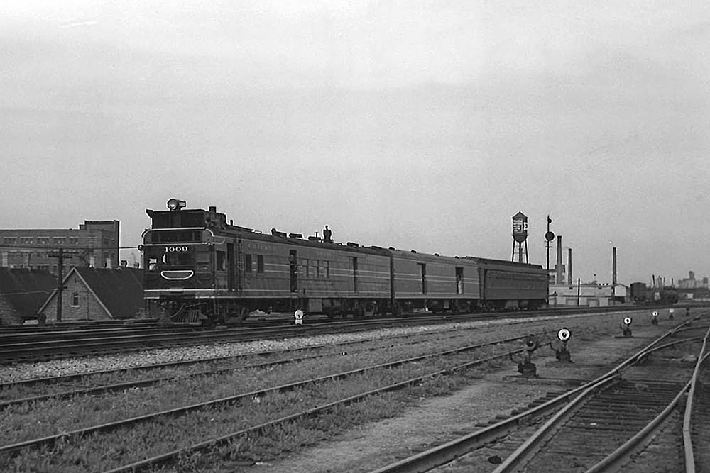 Motorcar with baggage car and coach on multi-track main line
