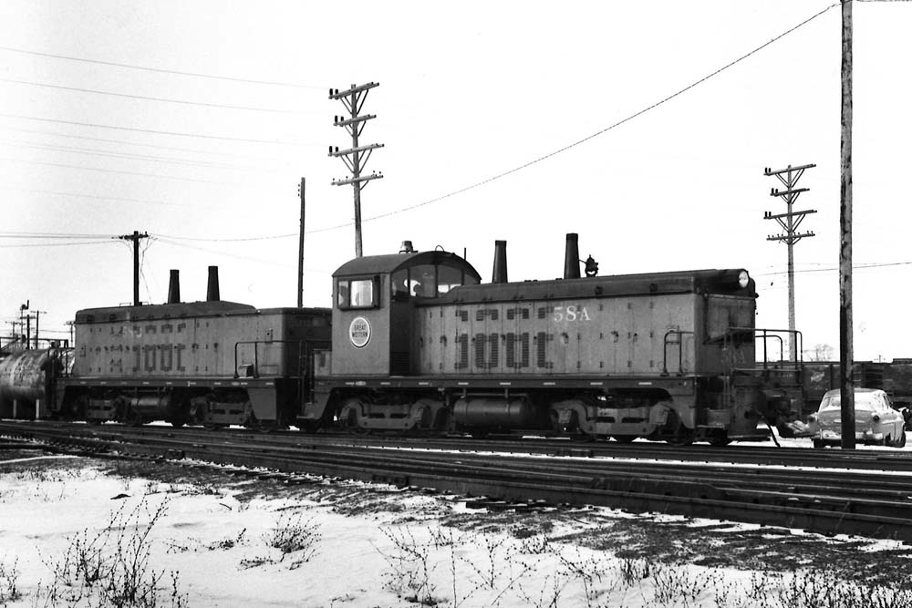 Diesel locomotives in a yard with snow