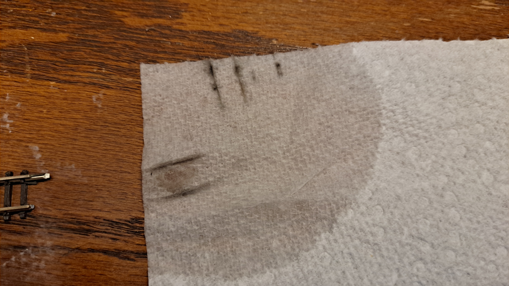 Piece of paper towel with streaks of dirt from locomotive drivers.