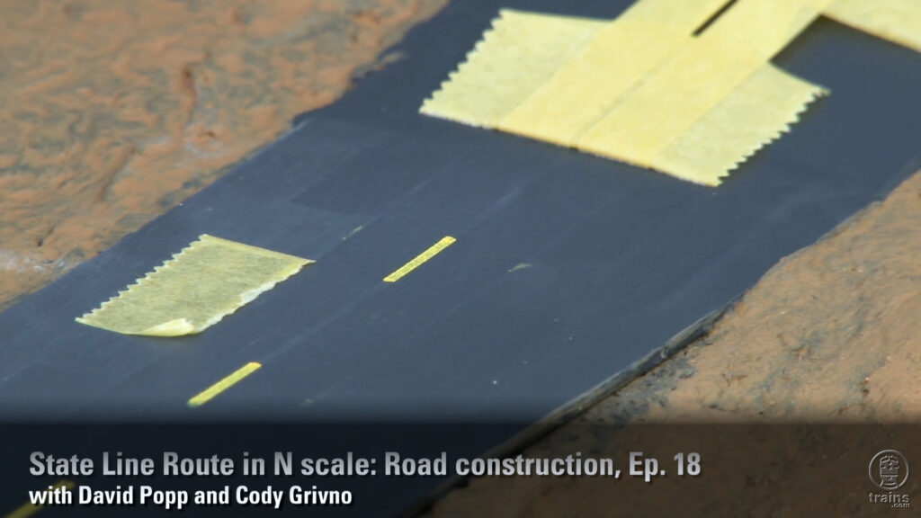 Center line yellow stripes on a roadway on a model railroad