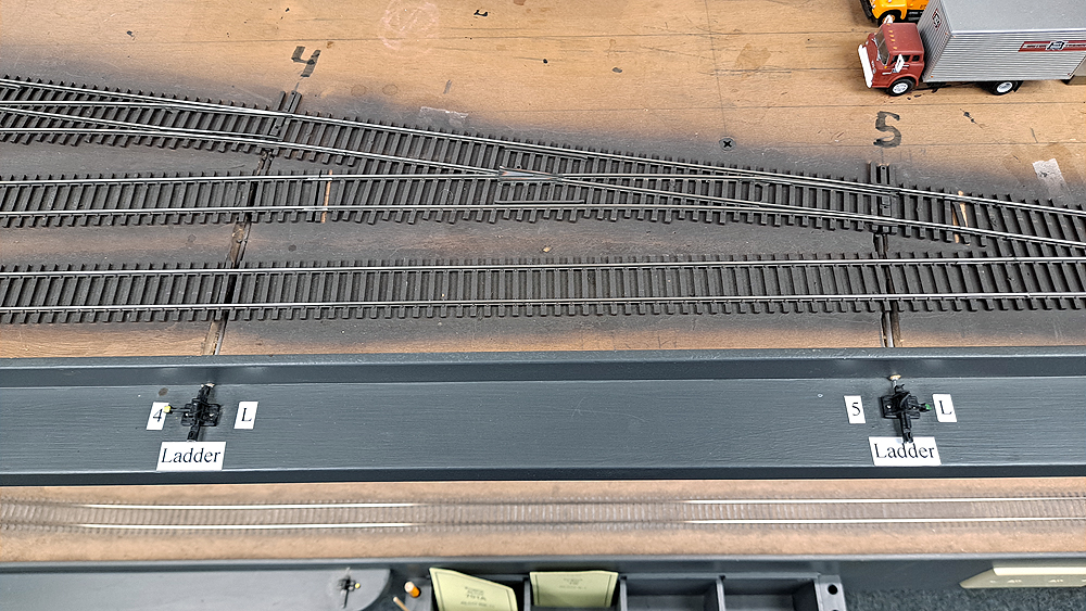 Caboose Industries ground throws are mounted to a shelf at the edge of the layout with actuating wires running through brass tubing to the turnouts.