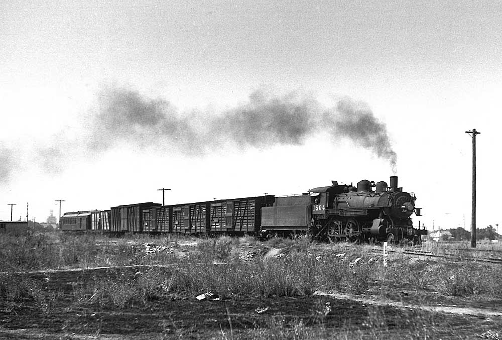 Southern Pacific freight trains: Mixed freight and passenger train behind small steam locomotive