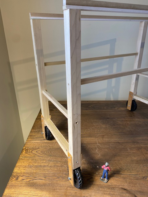 Wood body of a gantry crane with a model figure