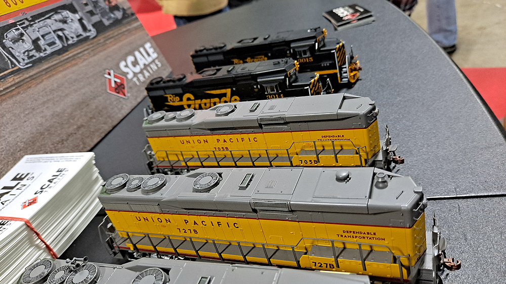 Cabless booster locomotives with darker gray roofs and yellow sides.