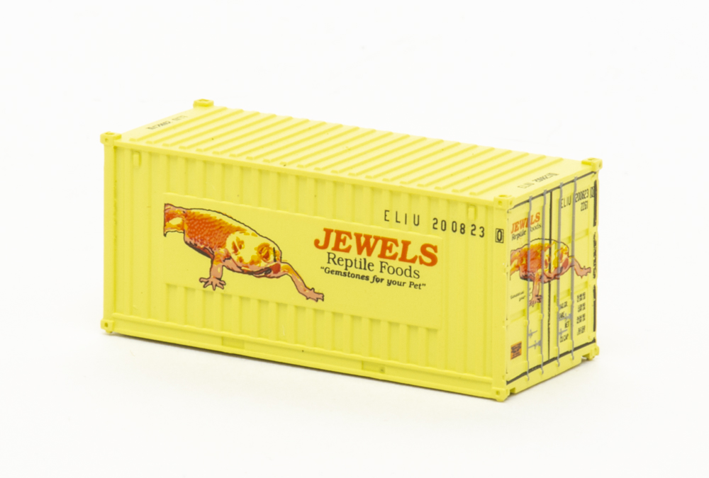 Photo of N scale 20-foot intermodal container painted yellow with red and black graphics.