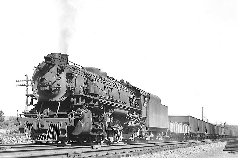 Steam locomotive on freight train in black and white