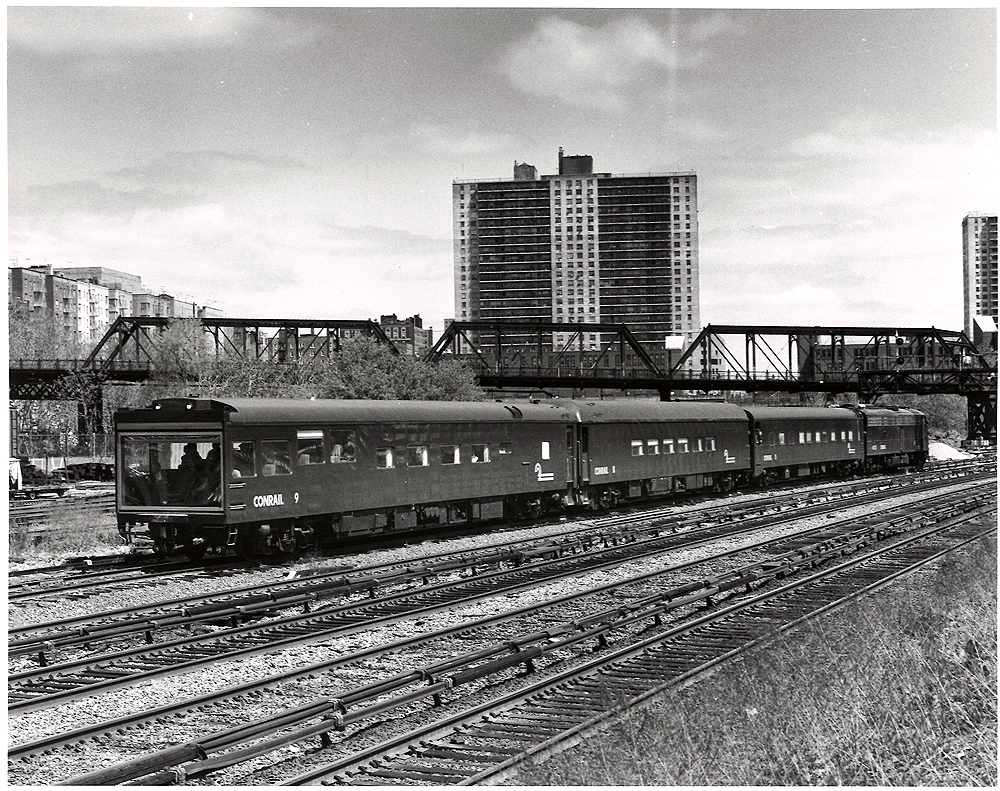 Conrail passenger trains: Inspection car lead by a streamlined locomotive.