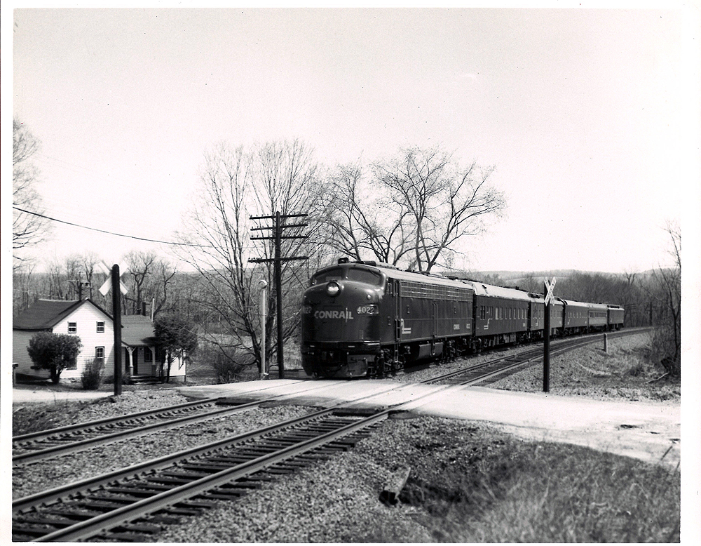 Conrail passenger trains: Streamlined locomotives lead a passenger train through the countryside.