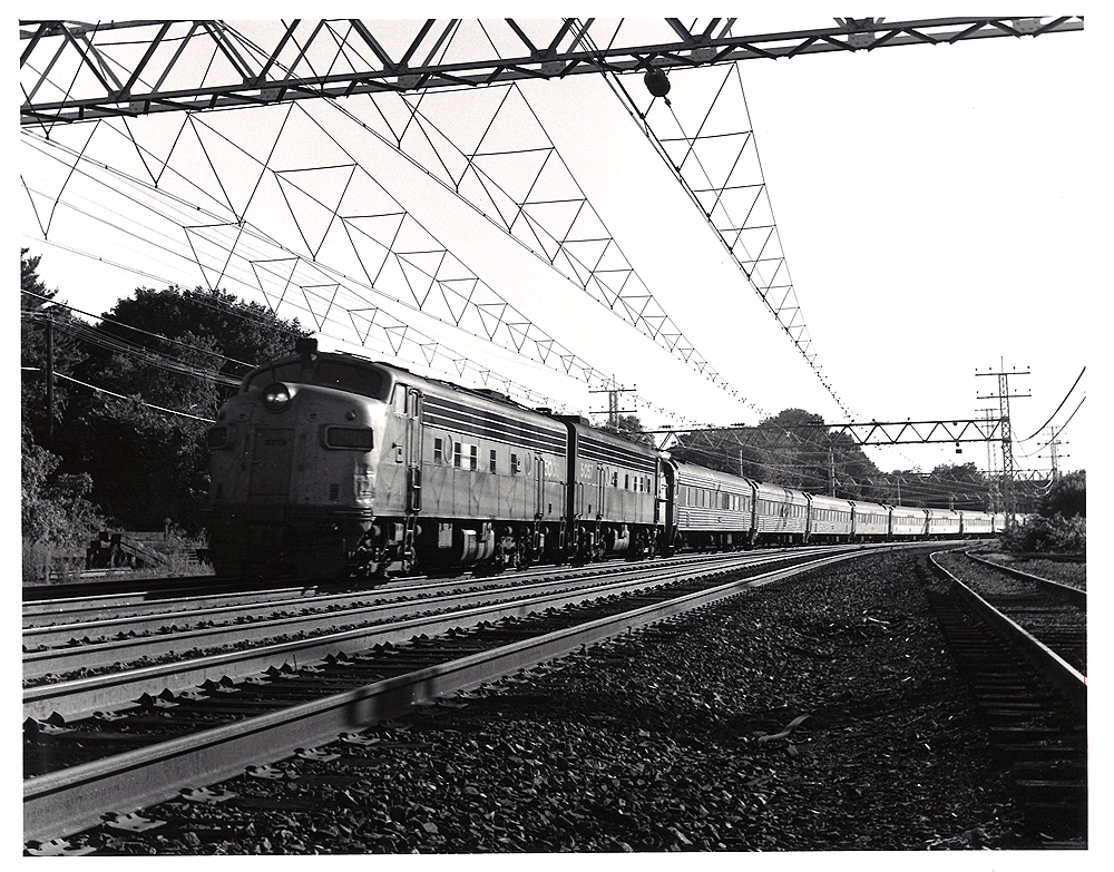 Conrail passenger trains: Streamlined locomotives lead a passenger train under catenary.