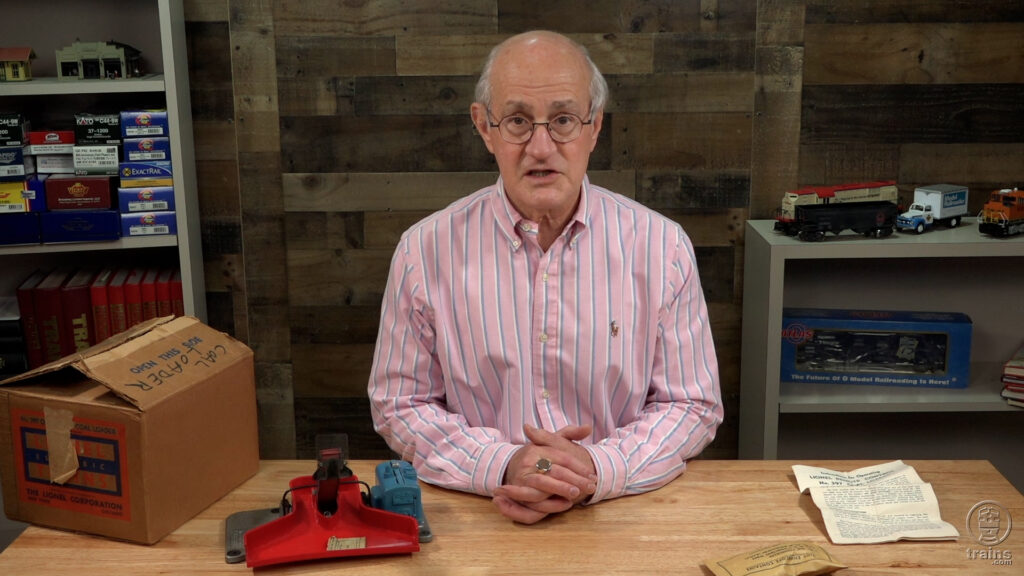 Man at a desk with toy train accessory