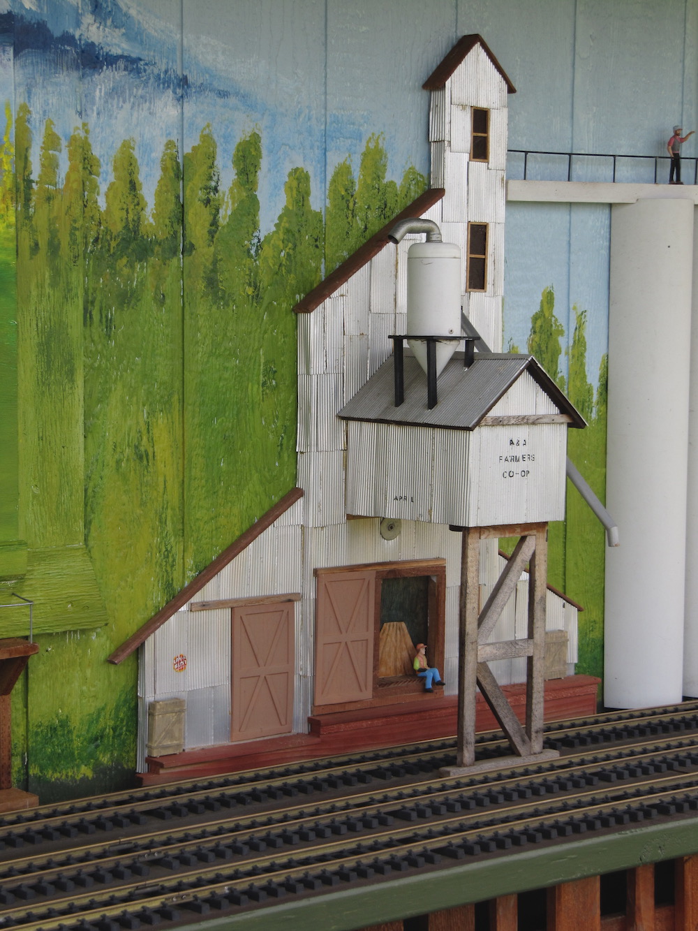 Low-relief model structure on the side of a fence.