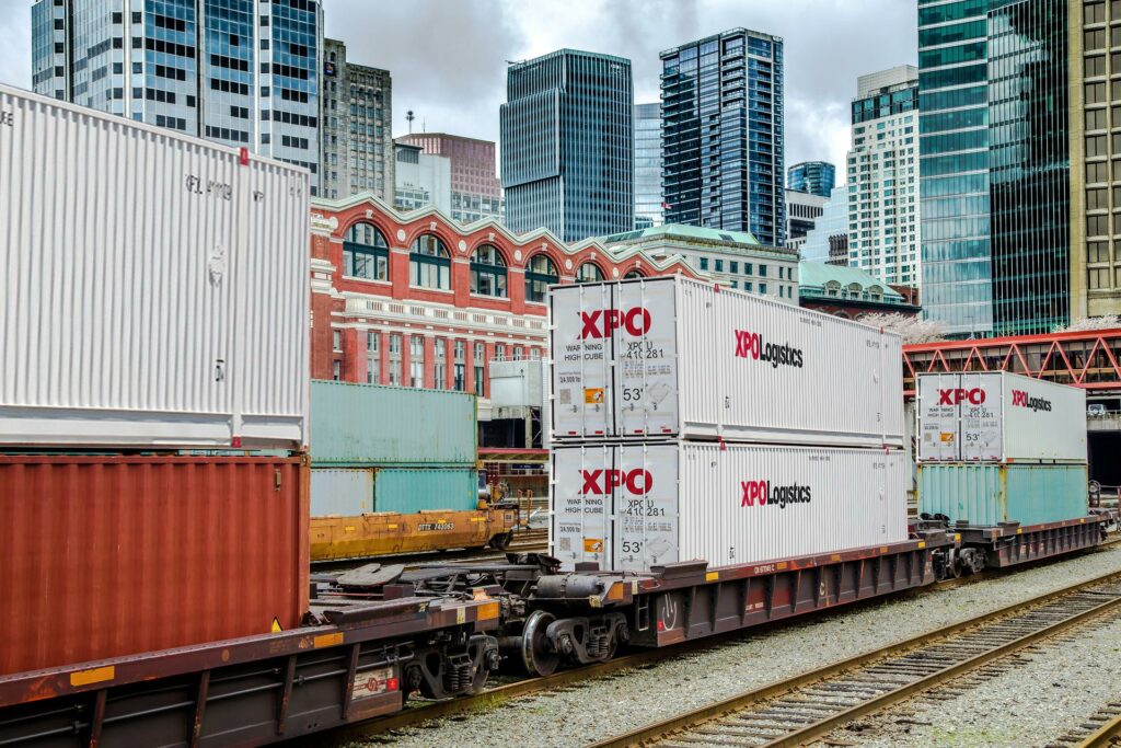 XPO Logistics containers on train with Vancouver, British Columbia, city skyline in background