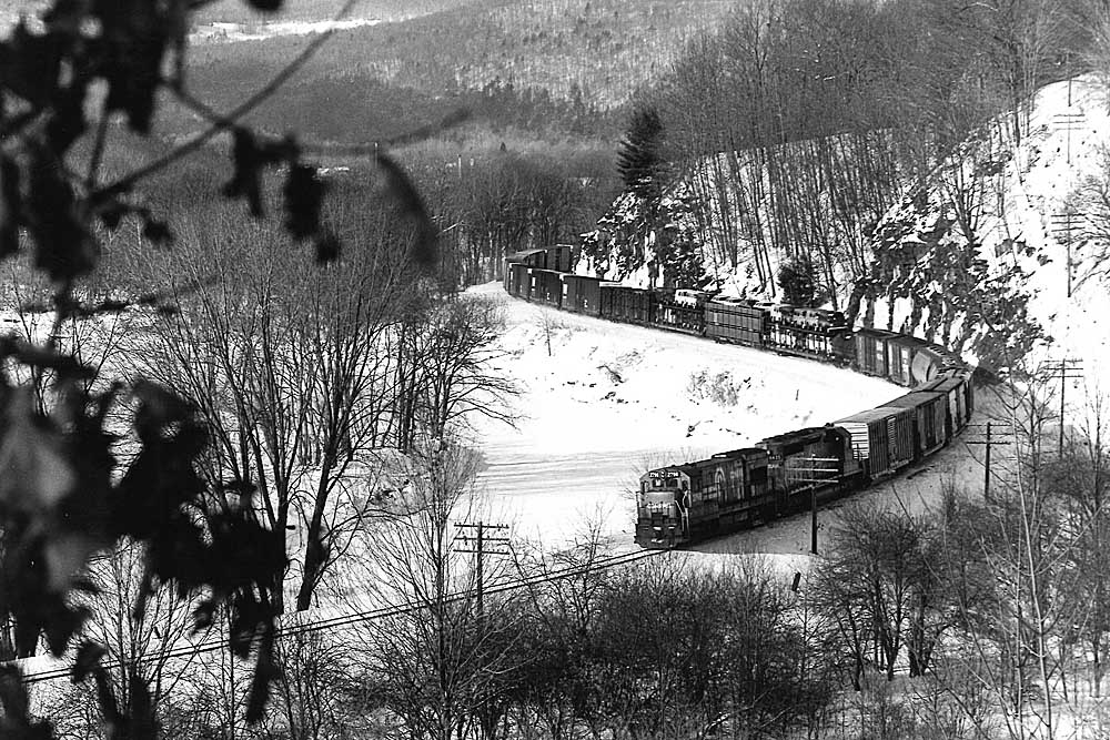 Conrail freight train on curve along river as seen from above