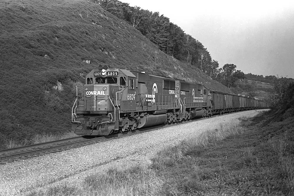 Diesel locomotives with coal train in treeless cut