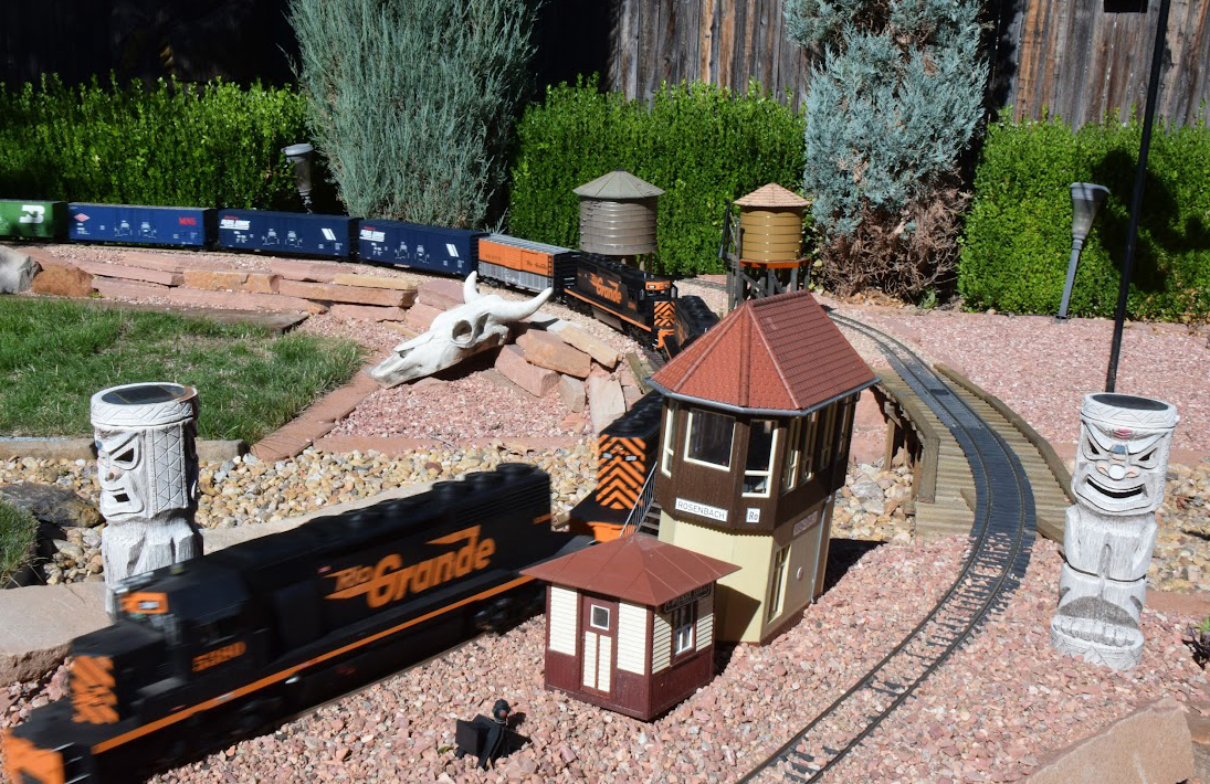 Model diesel engine speeding by curve with watch tower nearby