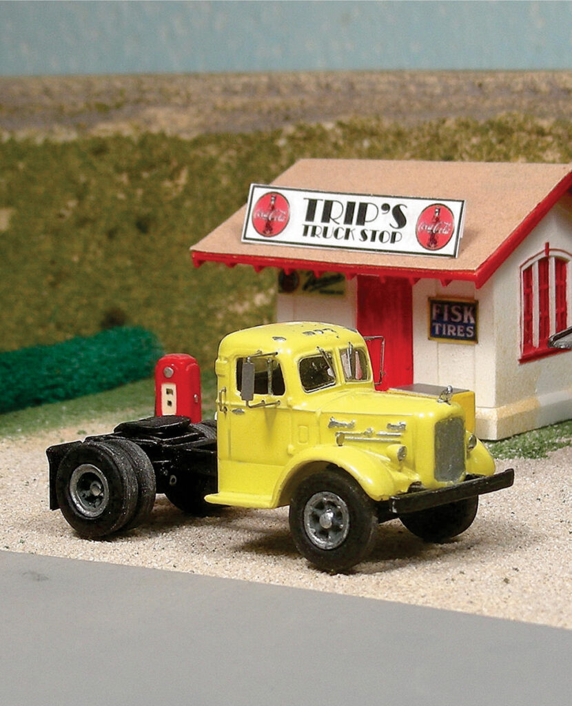 Yellow truck in front of structure