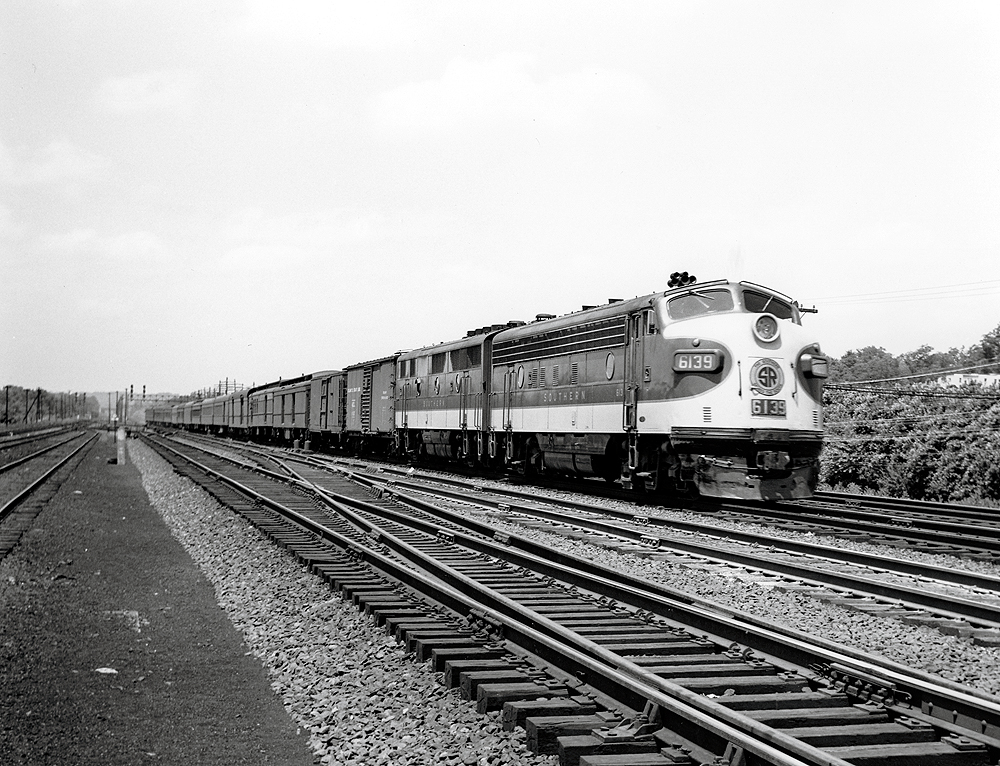 Streamlined locomotives leading a passenger train.
