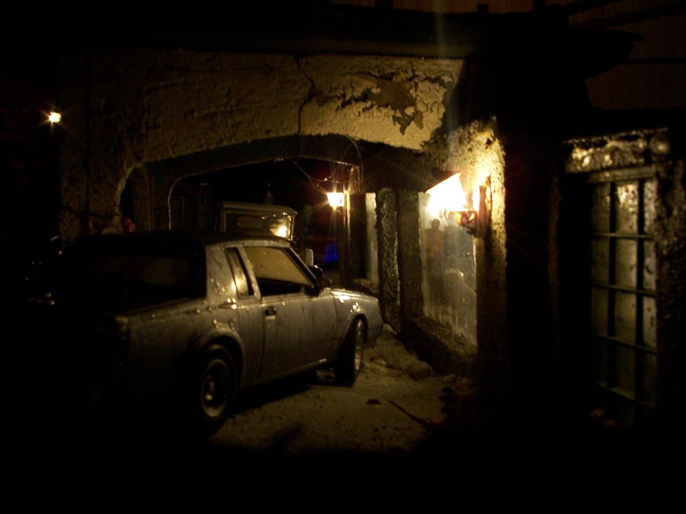 Night shot of a model car under a culvert