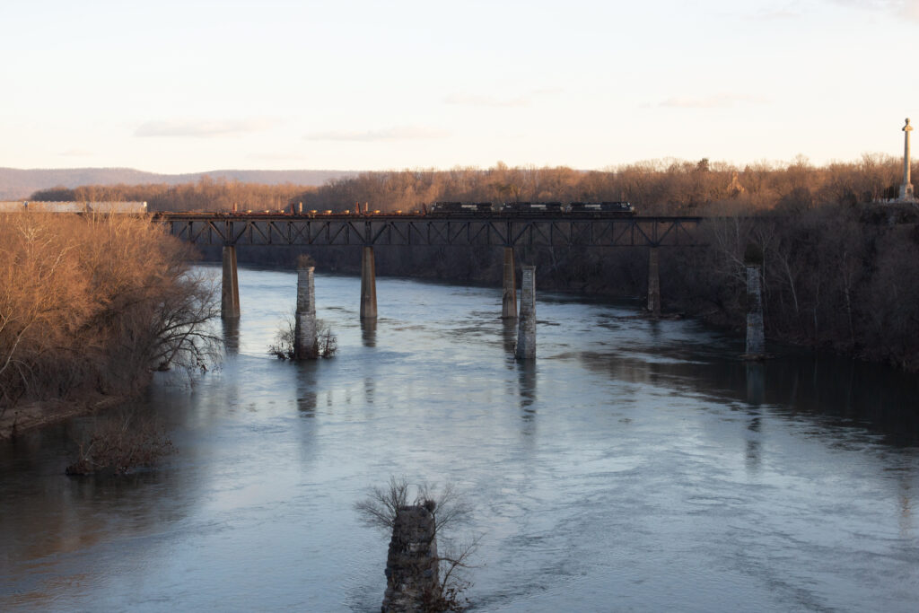 Train on tall bridge over river