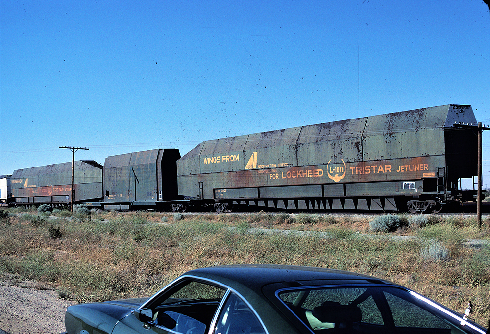Specialized flat car made to carry an airplane wing.