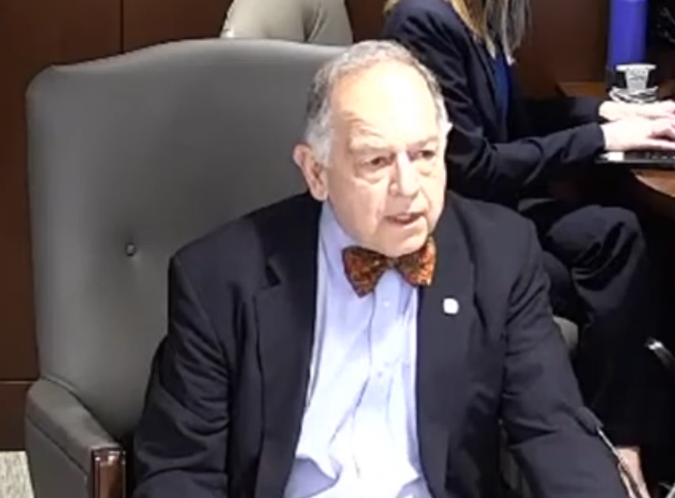 Man speaking from seat in hearing room