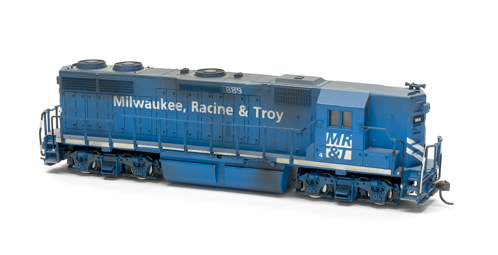HO scale four-axle road unit with high short hood painted blue with white graphics.