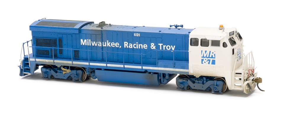 Photo of blue and white road locomotive on white background