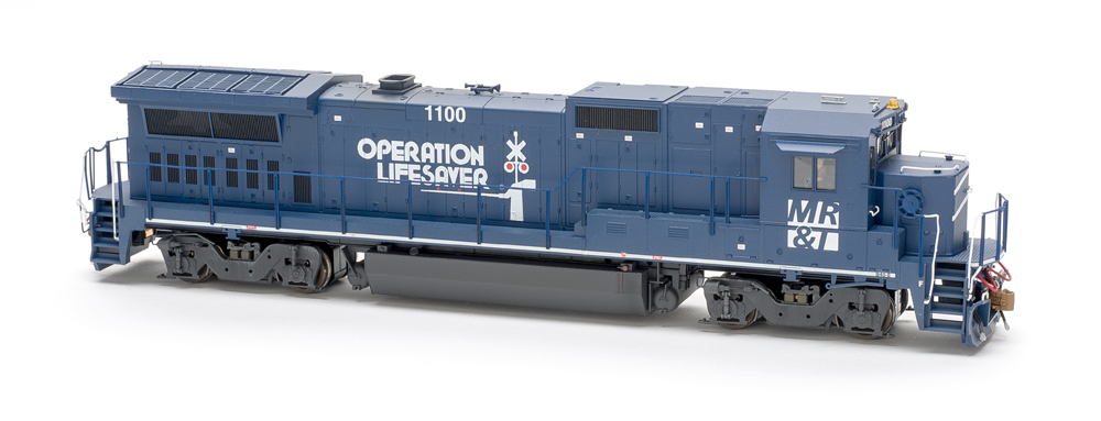 Photo of dark blue four-axle GE road unit on white background