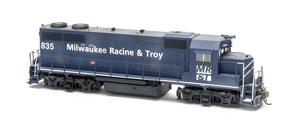 Photo of weathered dark blue road locomotive on white background
